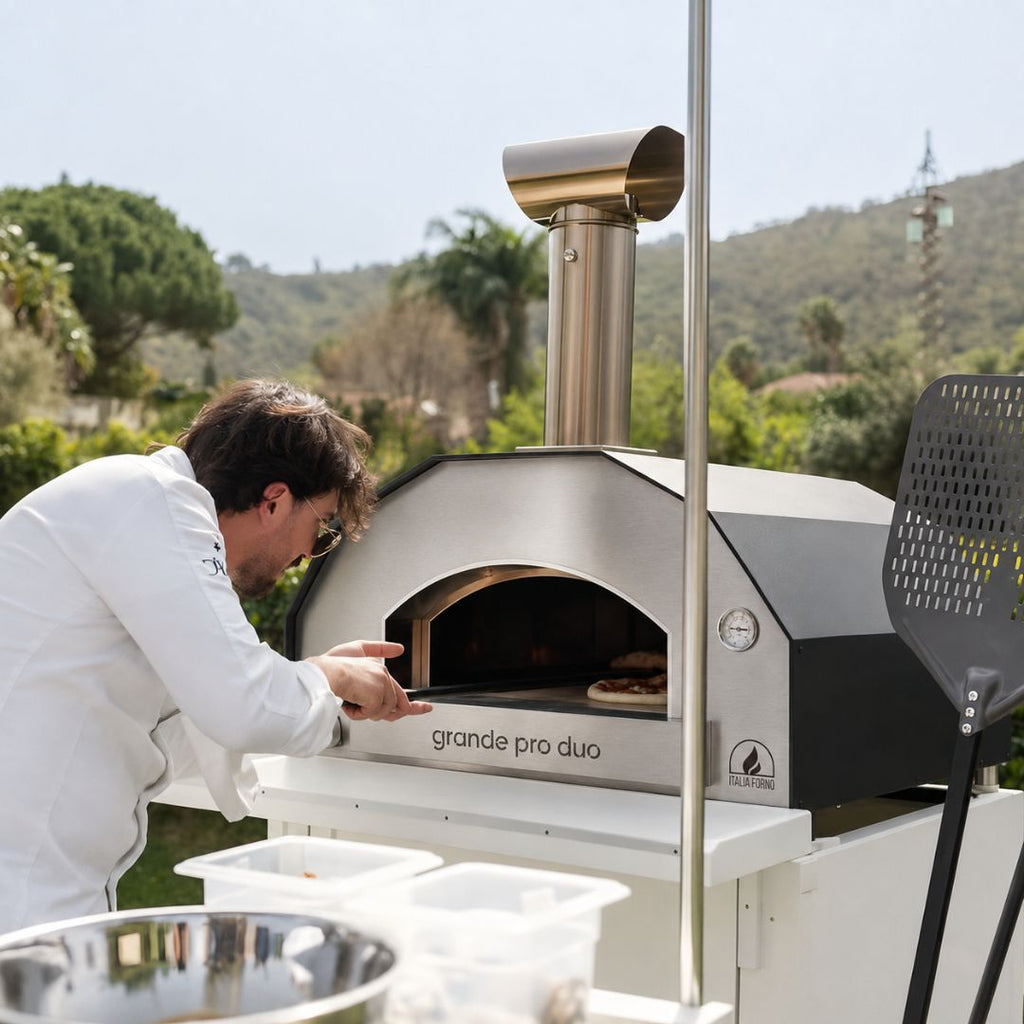 Professional Chef cooking a pizza in the ItaliaForno Grande Pro Duo Hybrid Pizza Oven