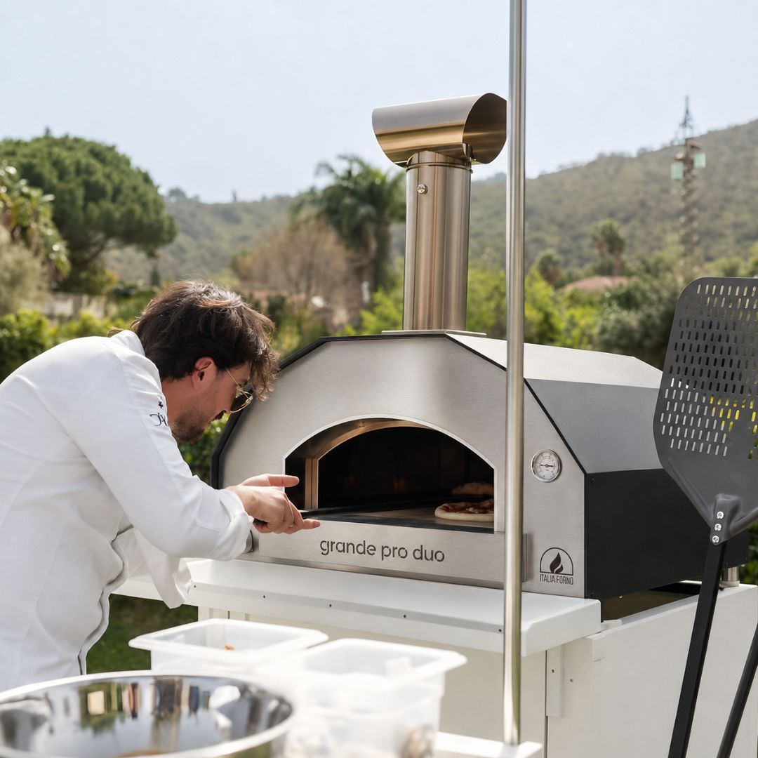 Professional Chef cooking a pizza in the ItaliaForno Grande Pro Duo Hybrid Pizza Oven